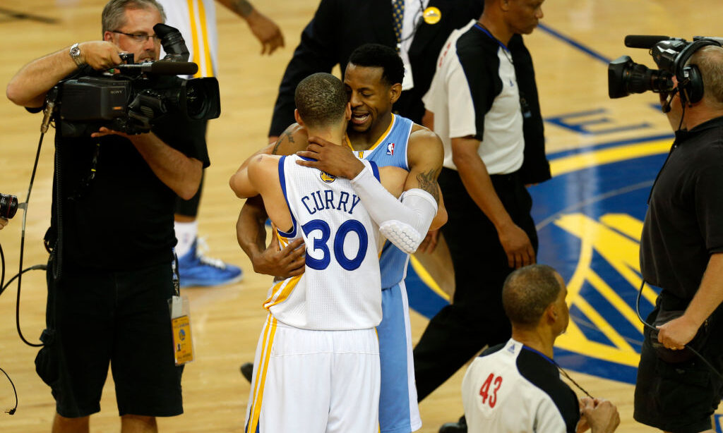 Golden State Warriors' Stephen Curry (30) talks to Denver Nuggets' Andre Iguodala (9) after the War...