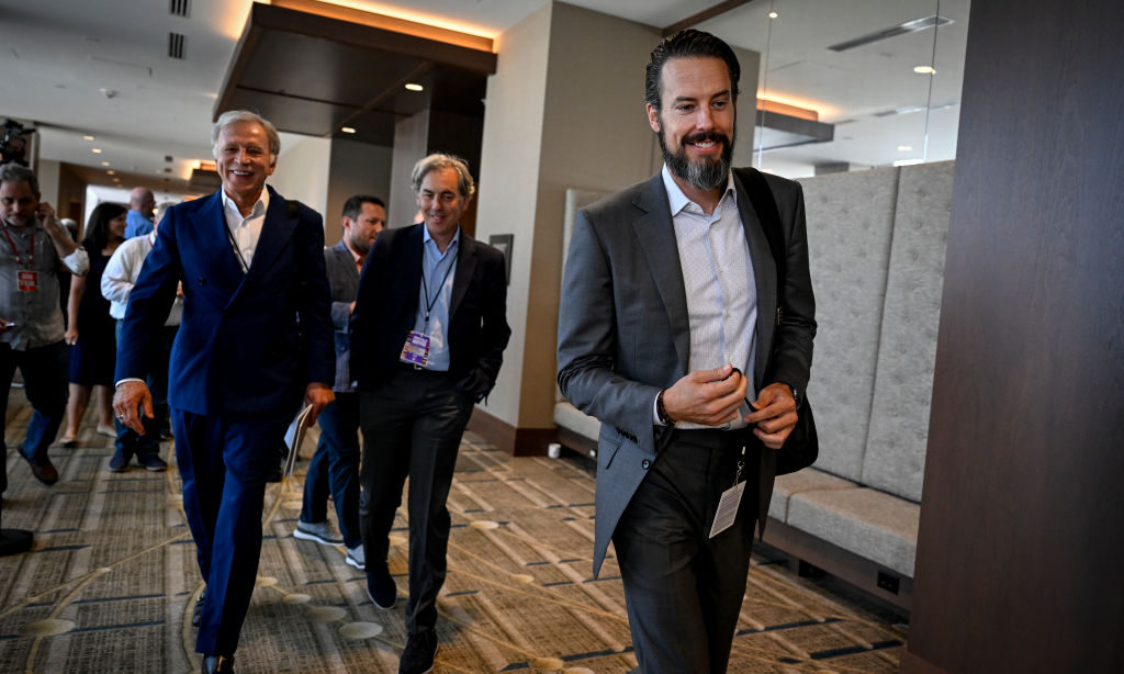 Stan Kroenke walks with son, Josh, and team president Kevin Demoff...