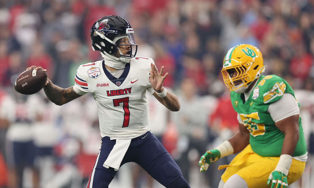 Quarterback Kaidon Salter #7 of the Liberty Flames throws a pass during the first half of the Fiest...