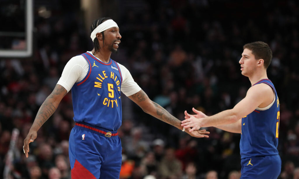Kentavious Caldwell-Pope #5 of the Denver Nuggets high fives Collin Gillespie #21...