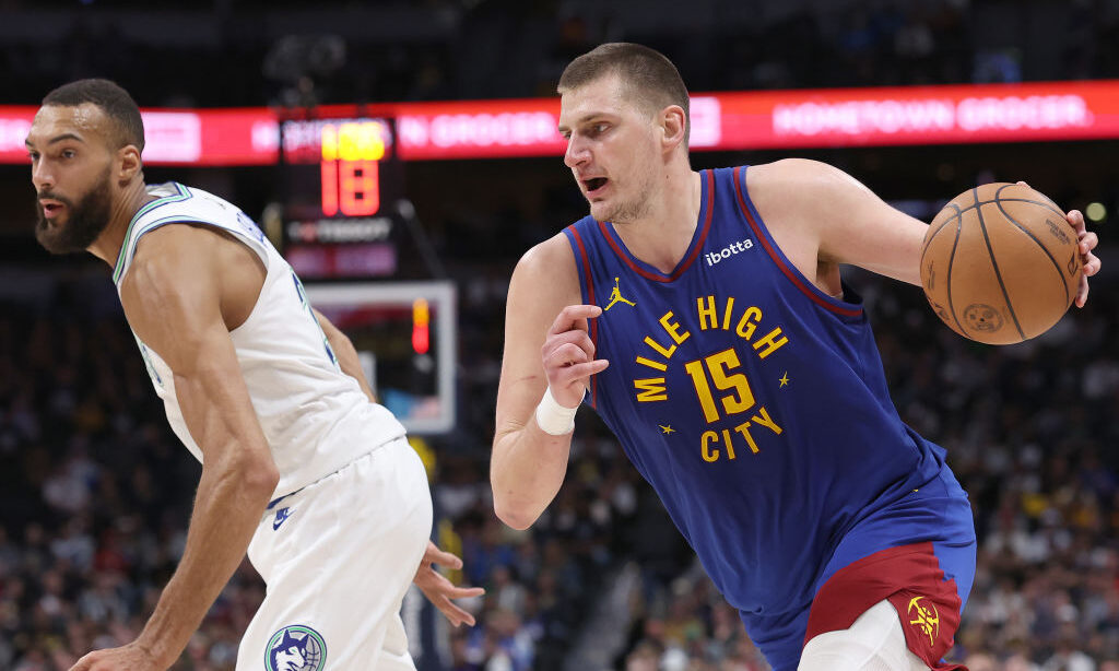 Nikola Jokic #15 of the Denver Nuggets drives against Rudy Gobert #27 of the Minnesota Timberwolves...