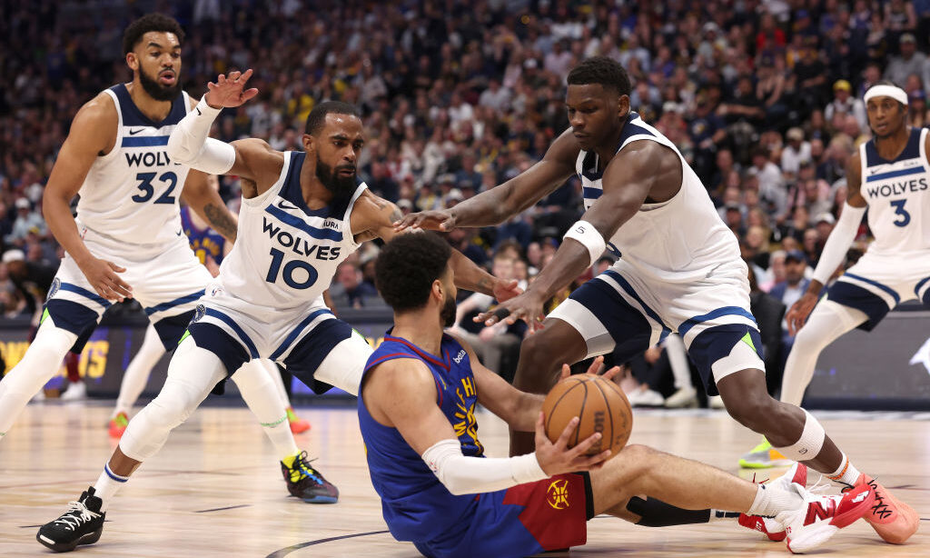 Jamal Murray #27 of the Denver Nuggets looks to passes the ball from the ground against Mike Conley...