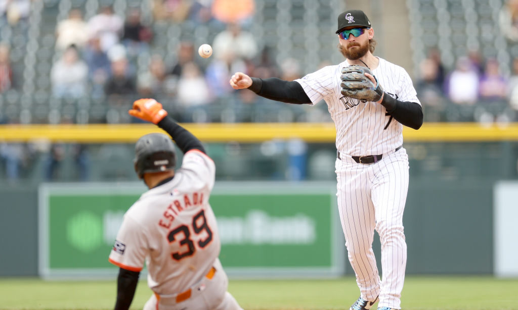 Brendan Rodgers #7 of the Colorado Rockies turns the first half of a double play against Thairo Est...