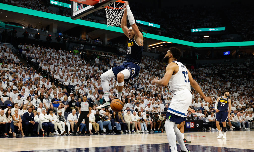 Aaron Gordon #50 of the Denver Nuggets dunks the ball while Karl-Anthony Towns #32 of the Minnesota...