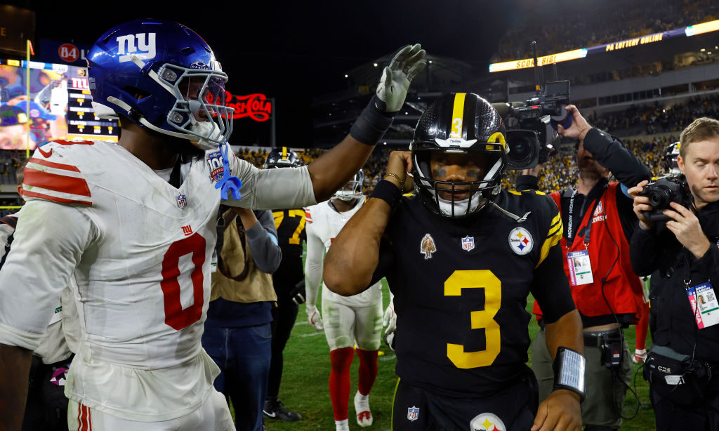 Brian Burns #0 of the New York Giants interacts with Russell Wilson #3 of the Pittsburgh Steelers a...