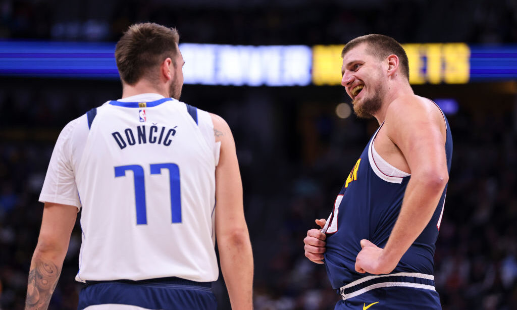 Luka Doncic #77 of the Dallas Mavericks and Nikola Jokic #15 of the Denver Nuggets...