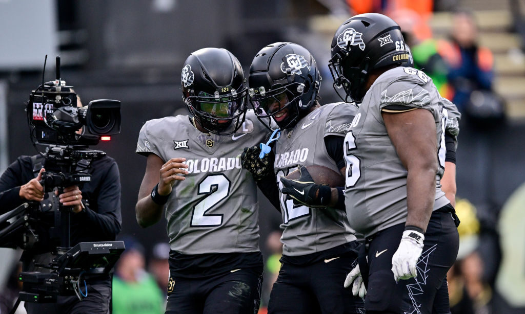 Shedeur Sanders #2 and Travis Hunter #12 of the Colorado Buffaloes celebrate after Hunter scored a ...