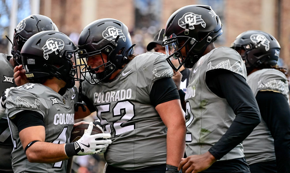 Charlie Offerdahl #44 of the Colorado Buffaloes celebrates with Cash Cleveland #52 and Shedeur Sand...