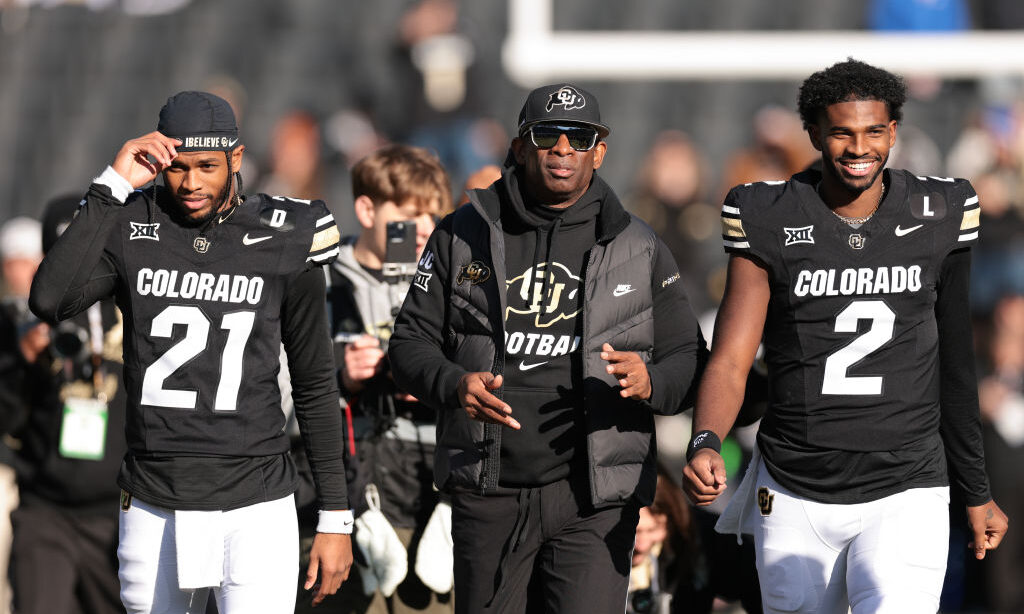 Head coach Deion "Coach Prime" Sanders and Shedeur Sanders #2 of the Colorado Buffaloes walk the fi...
