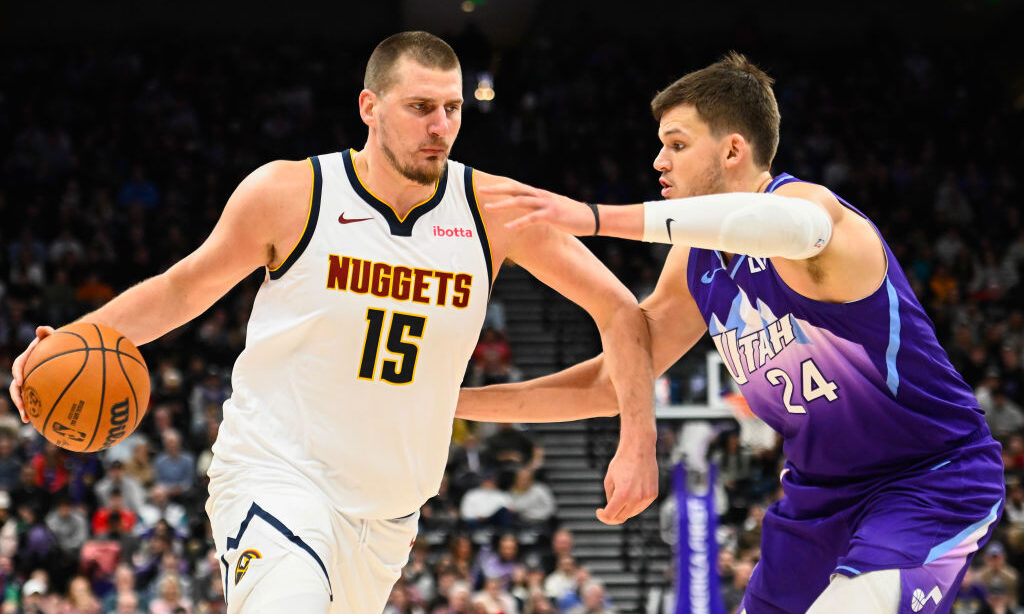 Nikola Jokic #15 of the Denver Nuggets drives into Walker Kessler #24 of the Utah Jazz...