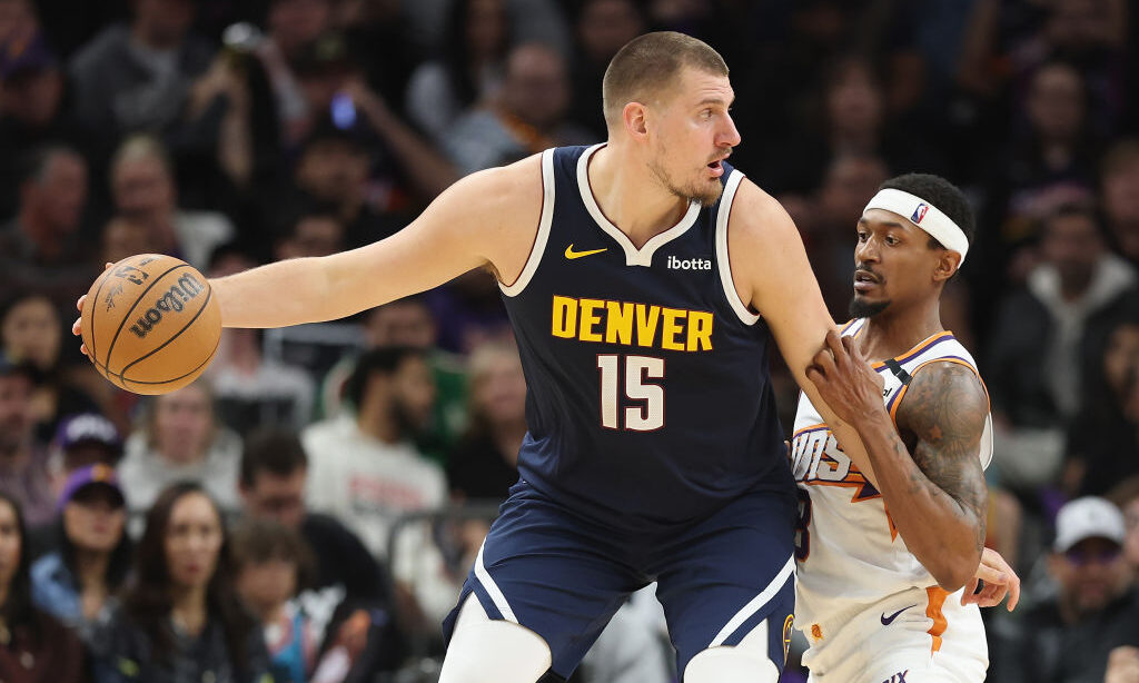 Nikola Jokic #15 of the Denver Nuggets handles the ball against Bradley Beal #3 of the Phoenix Suns...