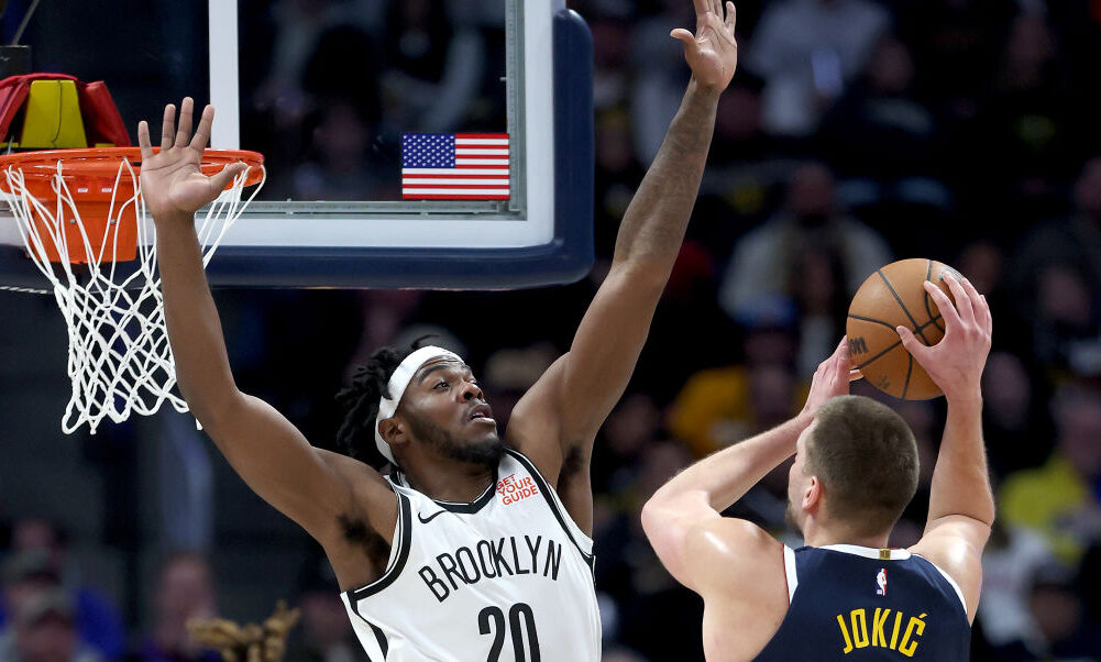 Nikola Jokic #15 of the Denver Nuggets goes to the basket against Day'Ron Sharpe #20 of the Brookly...