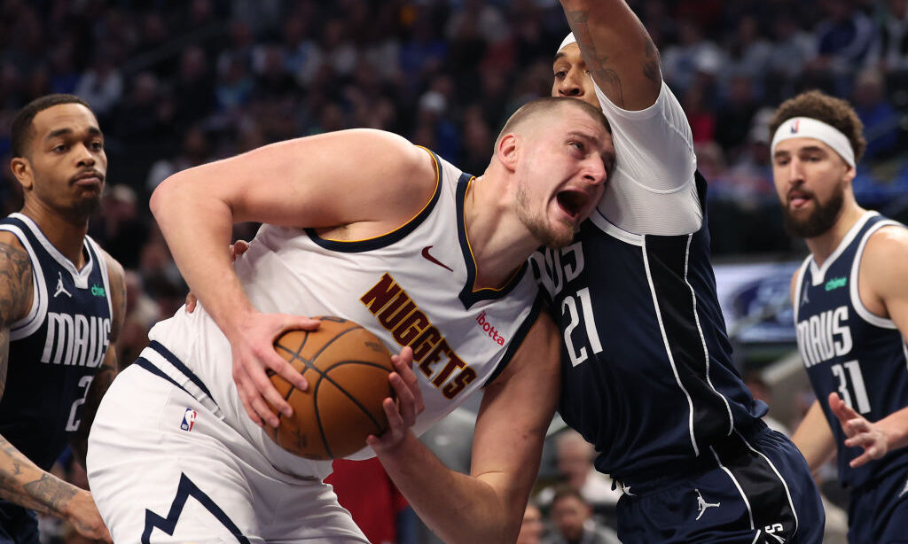 Nikola Jokic #15 of the Denver Nuggets is defended by Daniel Gafford #21 of the Dallas Mavericks du...
