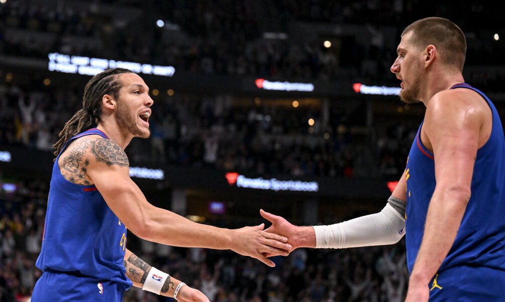 Aaron Gordon (32) greets Nikola Jokic (15) of the Denver Nuggets after Jokic hit a full-court heave...