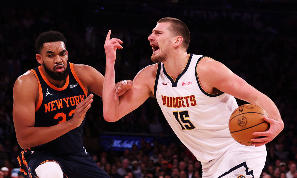 Nikola Jokic #15 of the Denver Nuggets is fouled by Karl-Anthony Towns #32 of the New York Knicks d...