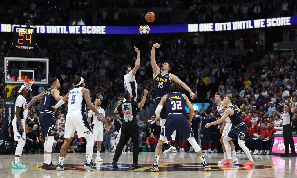 DENVER, COLORADO - FEBRUARY 06: Goga Bitadze #35 of the Orlando Magic tips off against Nikola Jokic...