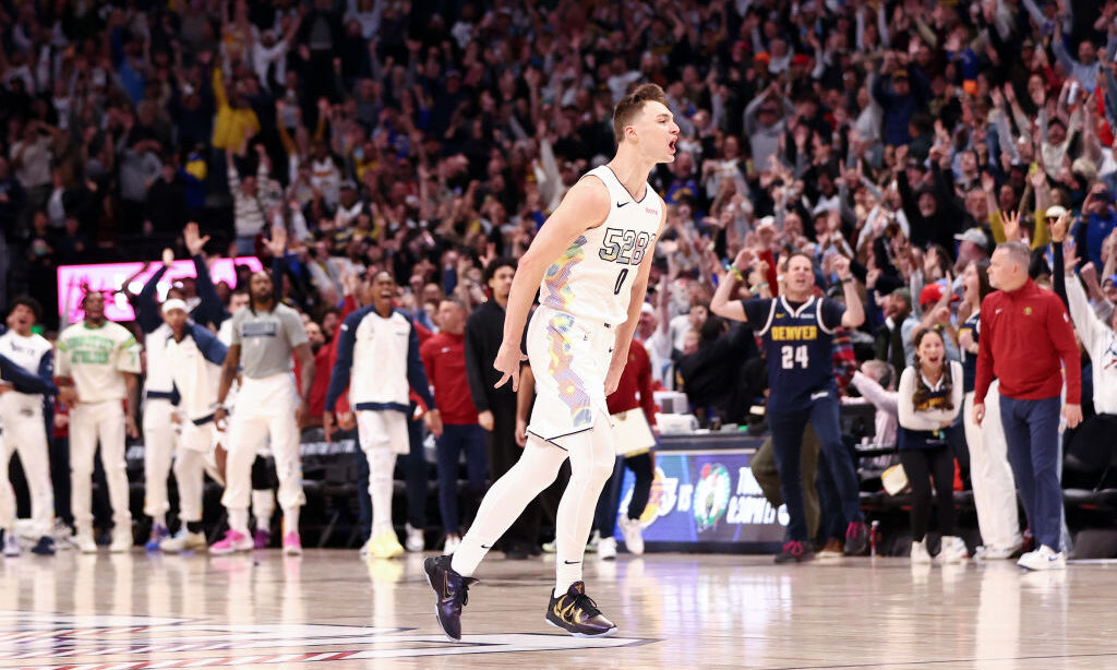 DENVER, COLORADO - MARCH 07: Christian Braun #0 of the Denver Nuggets celebrates after a three poin...