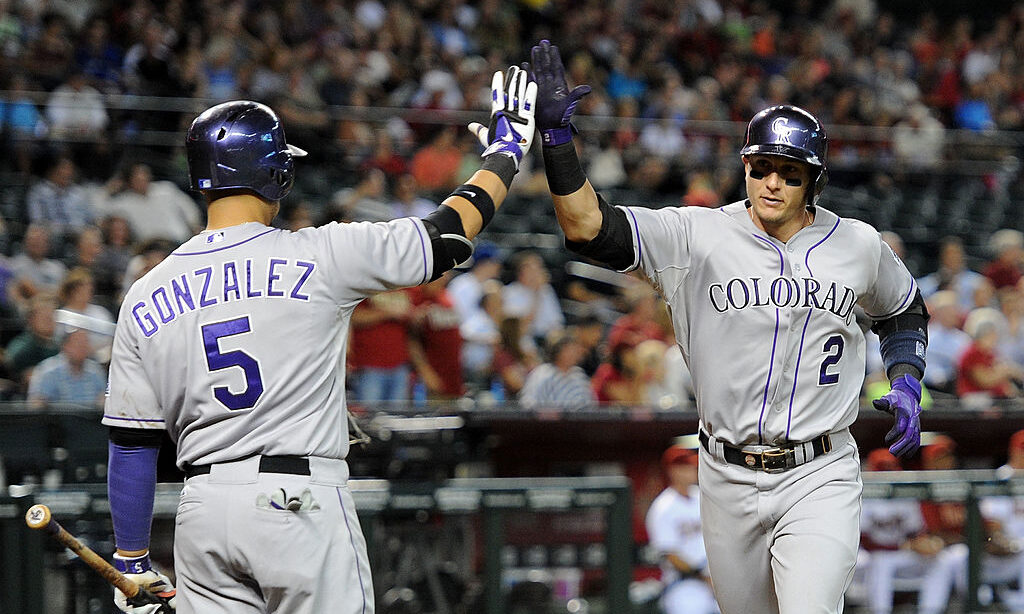 Troy Tulowitzki #2 of the Colorado Rockies is congratulated by teammate Carlos Gonzalez #5...